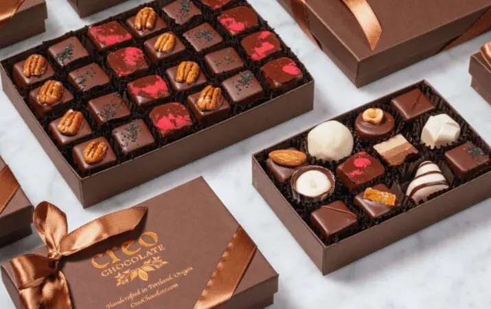 Assorted chocolates in brown boxes with ribbons, labeled 'Creo Chocolate'.
