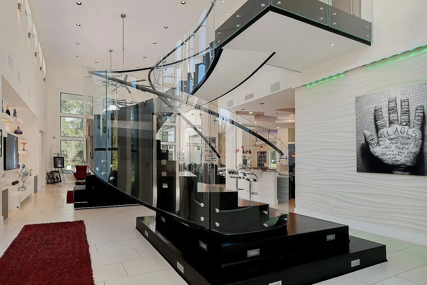 Modern interior with a black spiral staircase, white walls, and contemporary artwork.