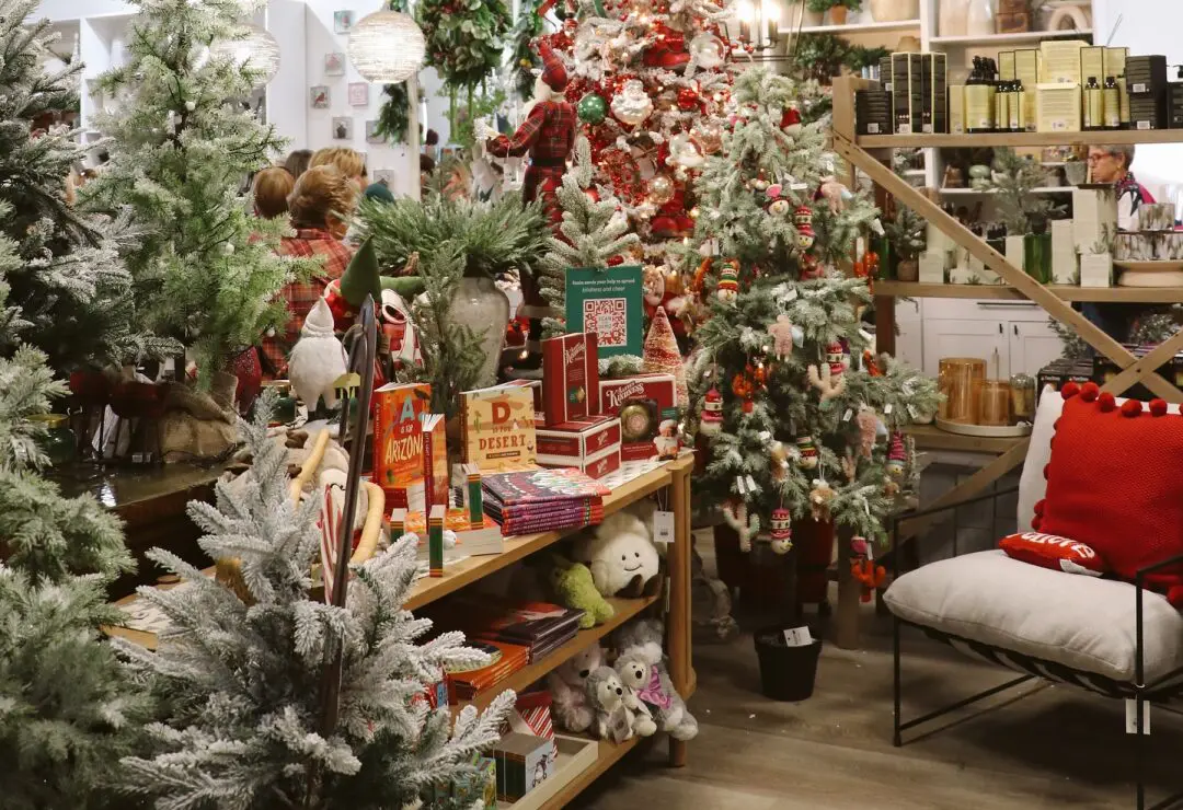 Christmas-themed store display with decorated trees, holiday gifts, and festive decorations.