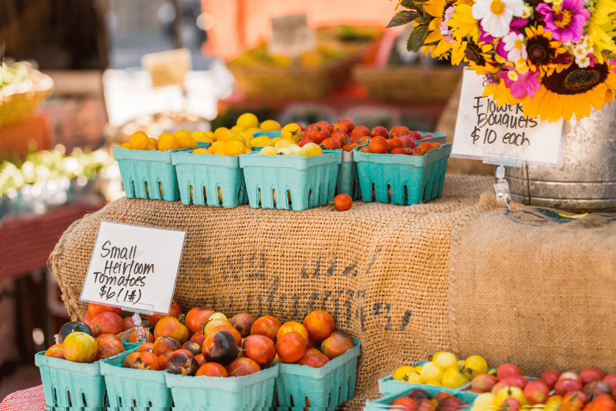 Various fruits for sale at a farmers market.