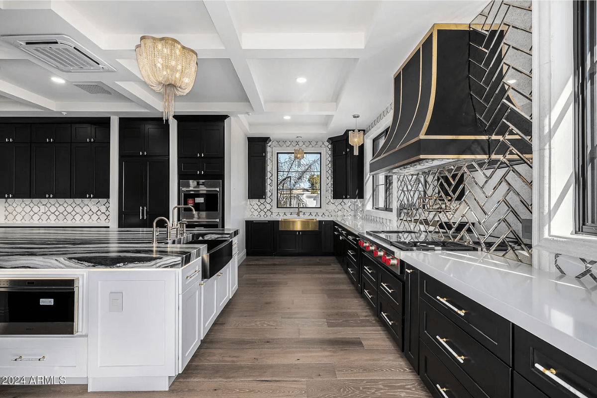 A luxury black and white kitchen.