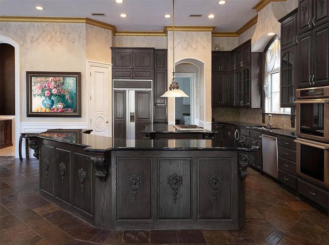 Luxurious kitchen with dark wood cabinets, large island, and elegant pendant lighting.
