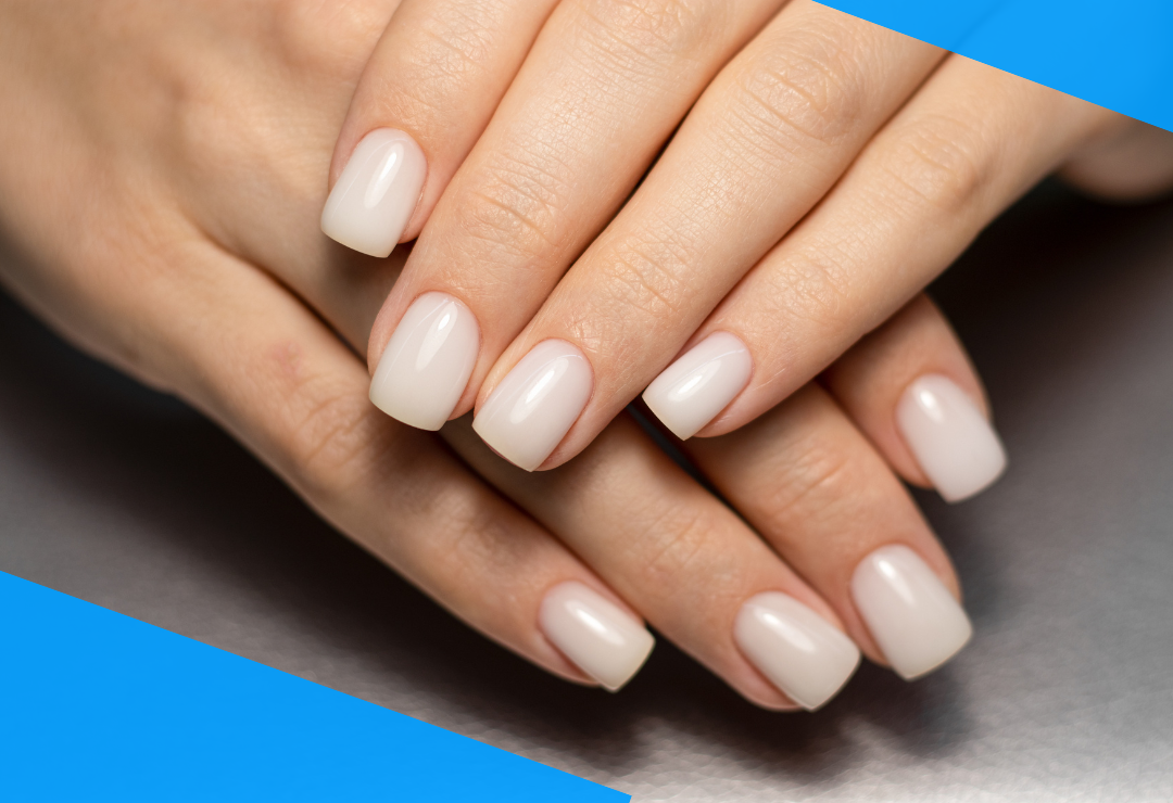 Hands with neatly manicured, glossy white nails on a metallic surface.