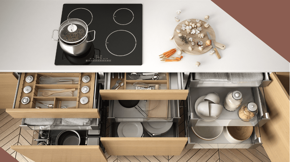 Top view of a kitchen with an induction stove, cooking pot, and organized drawers.