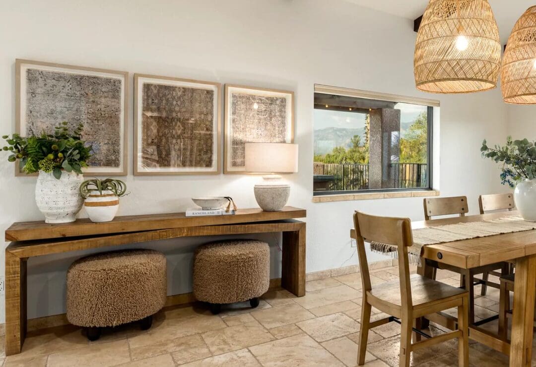 Dining area with wooden furniture, woven pendant lights, and framed artwork on the wall.